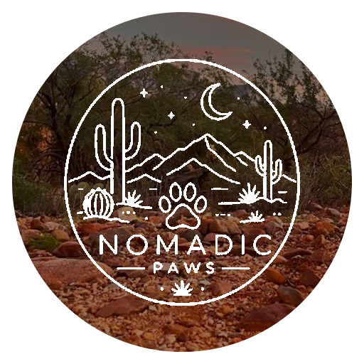 Nomadic Paws white desert logo over a Sonoran Desert background